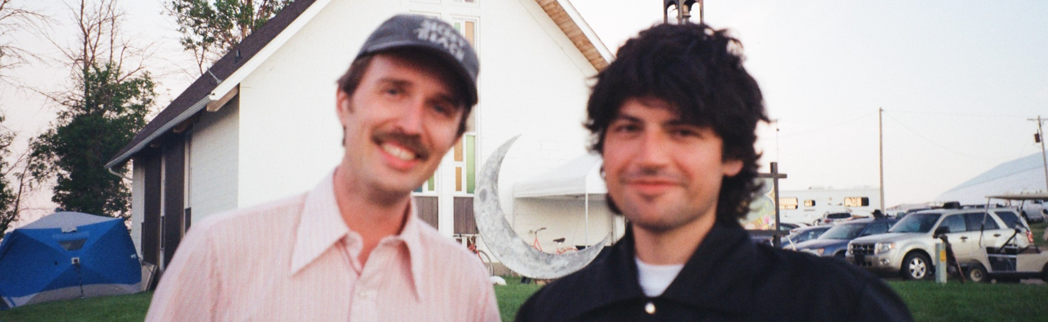 Clayton Linthicum and Quinn Bachand together outside a white church